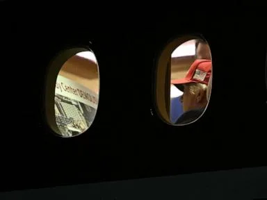Trump photographed looking over 'Kennedy Center DEMOLISHED' placard