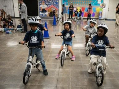 A childhood rite moves indoors as kindergartners learn to ride bikes in school gyms